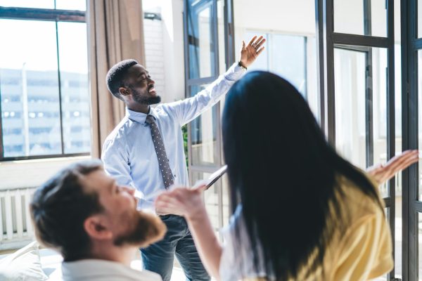 Real estate agent consulting couple in apartment