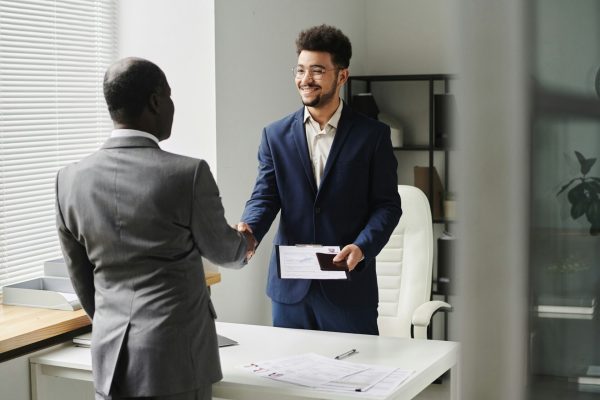 Specialist congratulating man of getting visa
